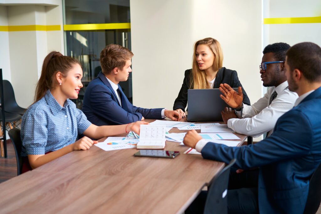 A sales intern leading a team meeting.